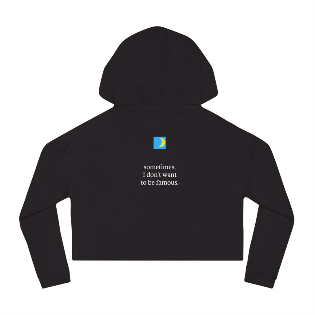 Back view of moontiq 'incognito' black cropped hoodie with moontiq logo, a small blue box with a yellow crescent moon and the text, 'sometimes I don't want to be famous'.