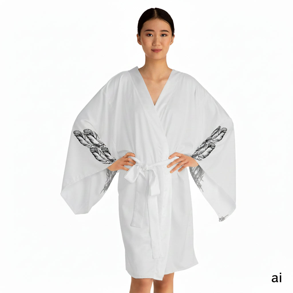 Front facing woman wearing the moontiq white kimono robe 'I Got Wings' with black angel feathers on the sleeves against a white background
