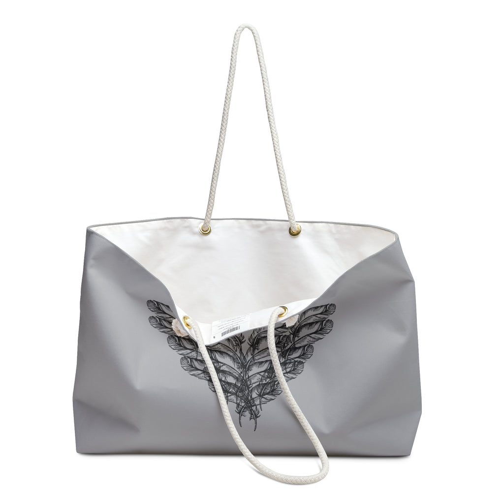 Close up view of clean white interior of the moontiq 'I Got Wings' heavenly gray tote bag with an angel wing design and white rope handles on a white background