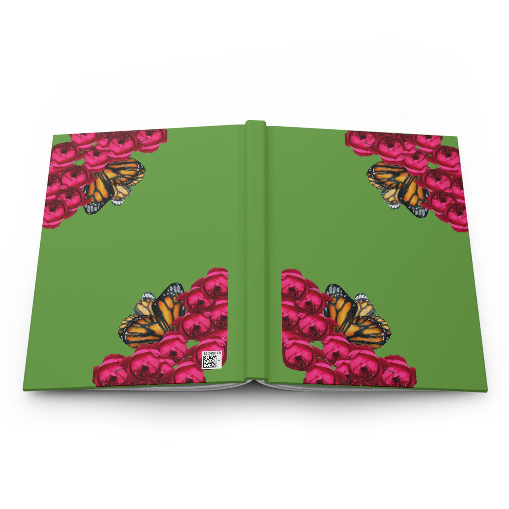 The green hard cover of a moontiq notebook journal 'Butterfly and Rose' featuring pink roses and orange butterflies.