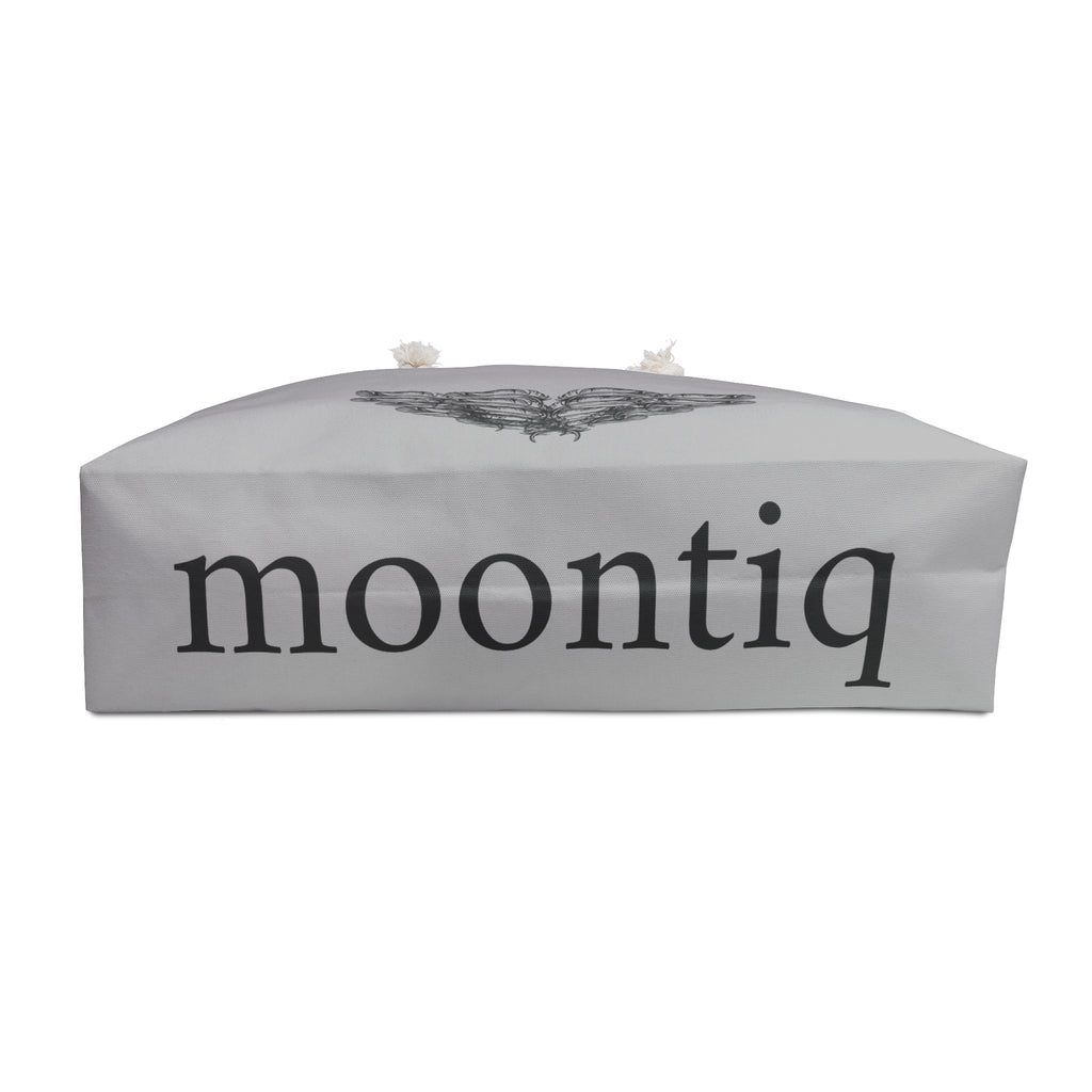 moontiq branding on the bottom of the 'I Got Wings' large heavenly gray tote bag with an angel wing design with white rope handles on a white background