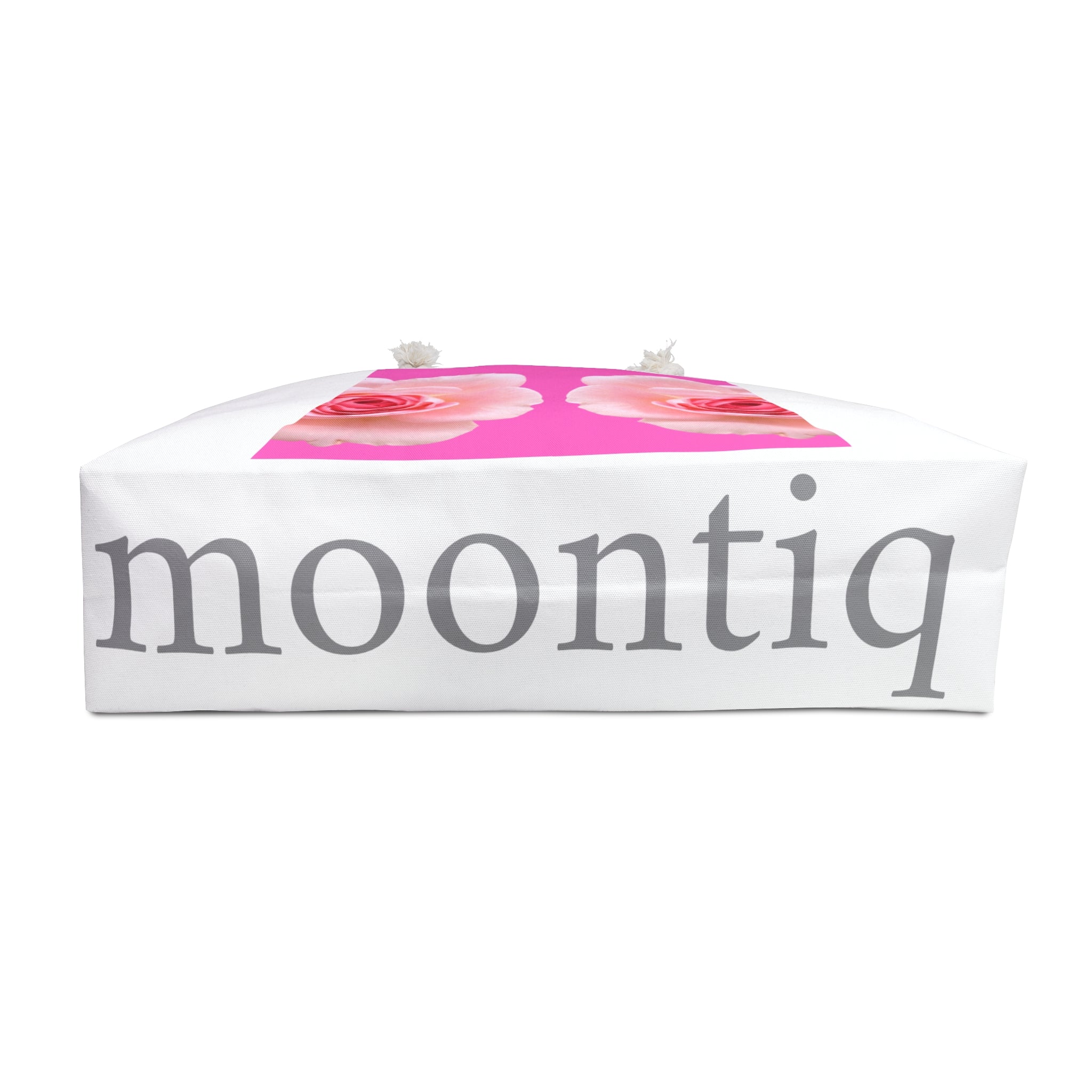 'moontiq' branding on the bottom of the 'rose and sorbet' white tote bag with pink rose design and white rope handles against a white background